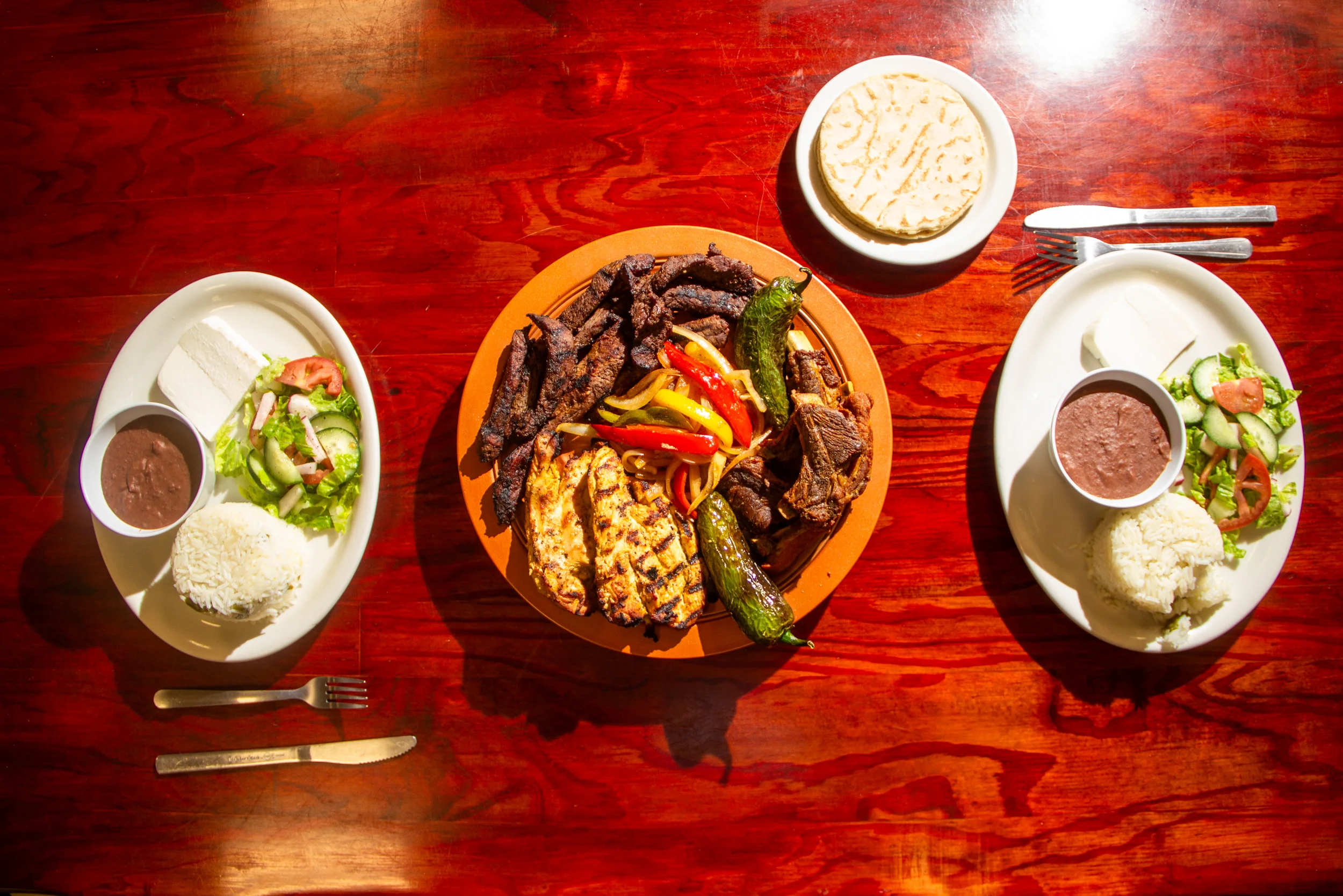 Sizzling Mexican fajitas served with rice and beans