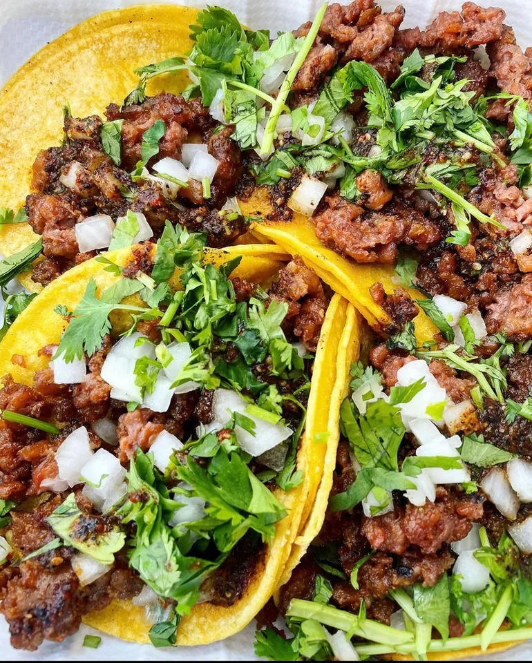 Authentic Mexican tacos al pastor topped with fresh cilantro