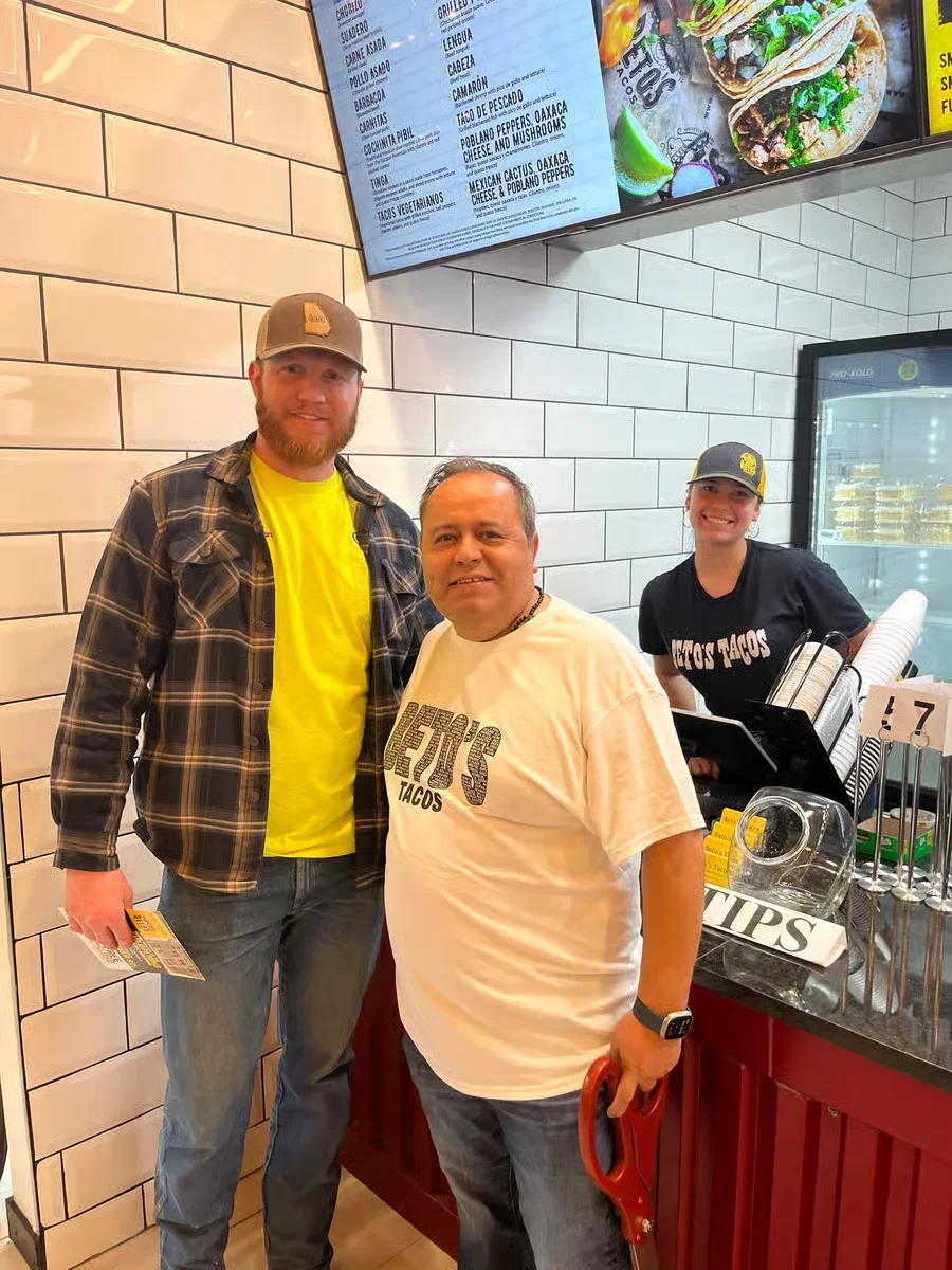 Customers enjoying tacos at a vibrant taco restaurant