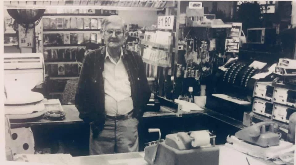 Vintage store interior with an elderly man behind the counter