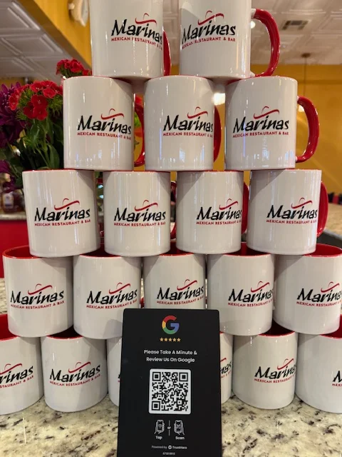 Display of Marinas restaurant mugs promoting Google reviews