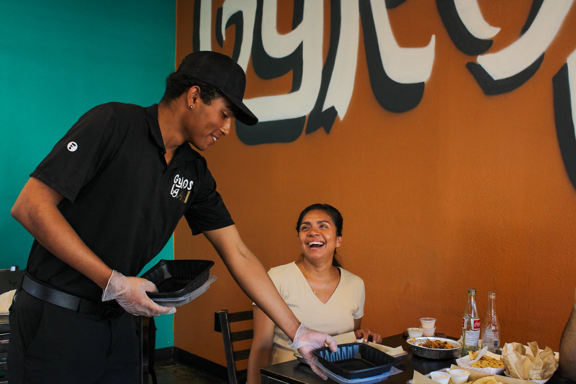 A waiter taking dishes from a customer's table