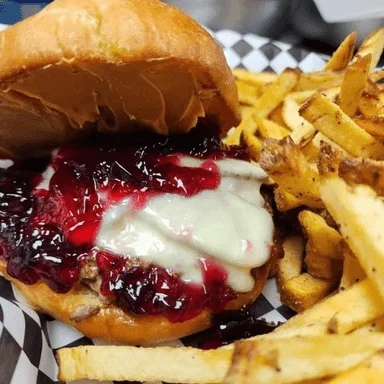 Savory Southern-style burger with grape jelly and fries