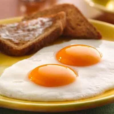 Classic American breakfast with sunny-side up eggs and toast