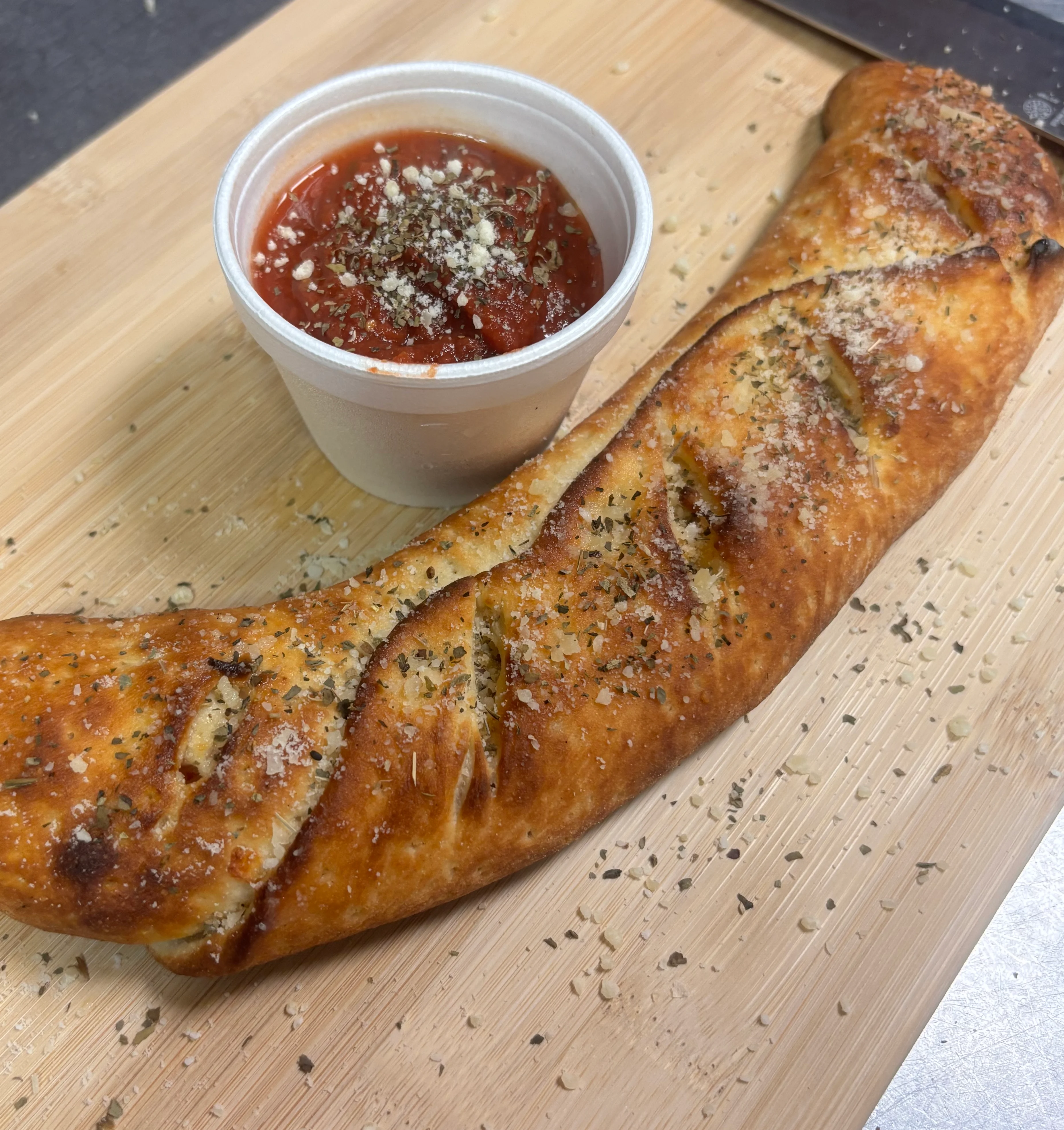 A top view of a classic pepperoni pizza with a golden crust and numerous slices of pepperoni on a cheese base.