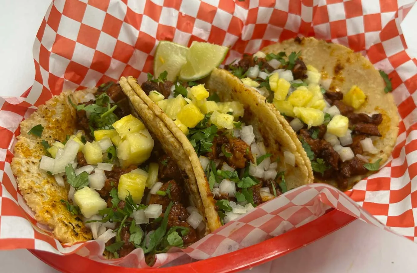 Authentic Mexican tacos al pastor with pineapple and cilantro