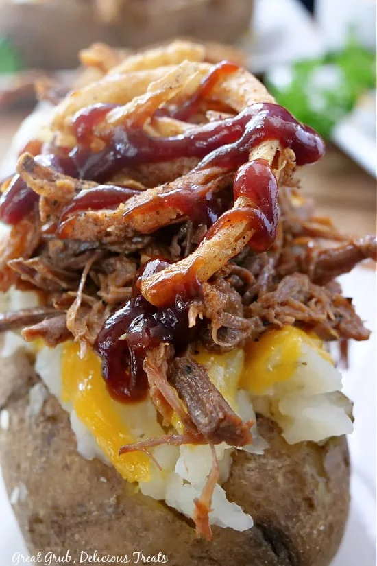 Loaded baked potato with pulled pork and barbecue sauce