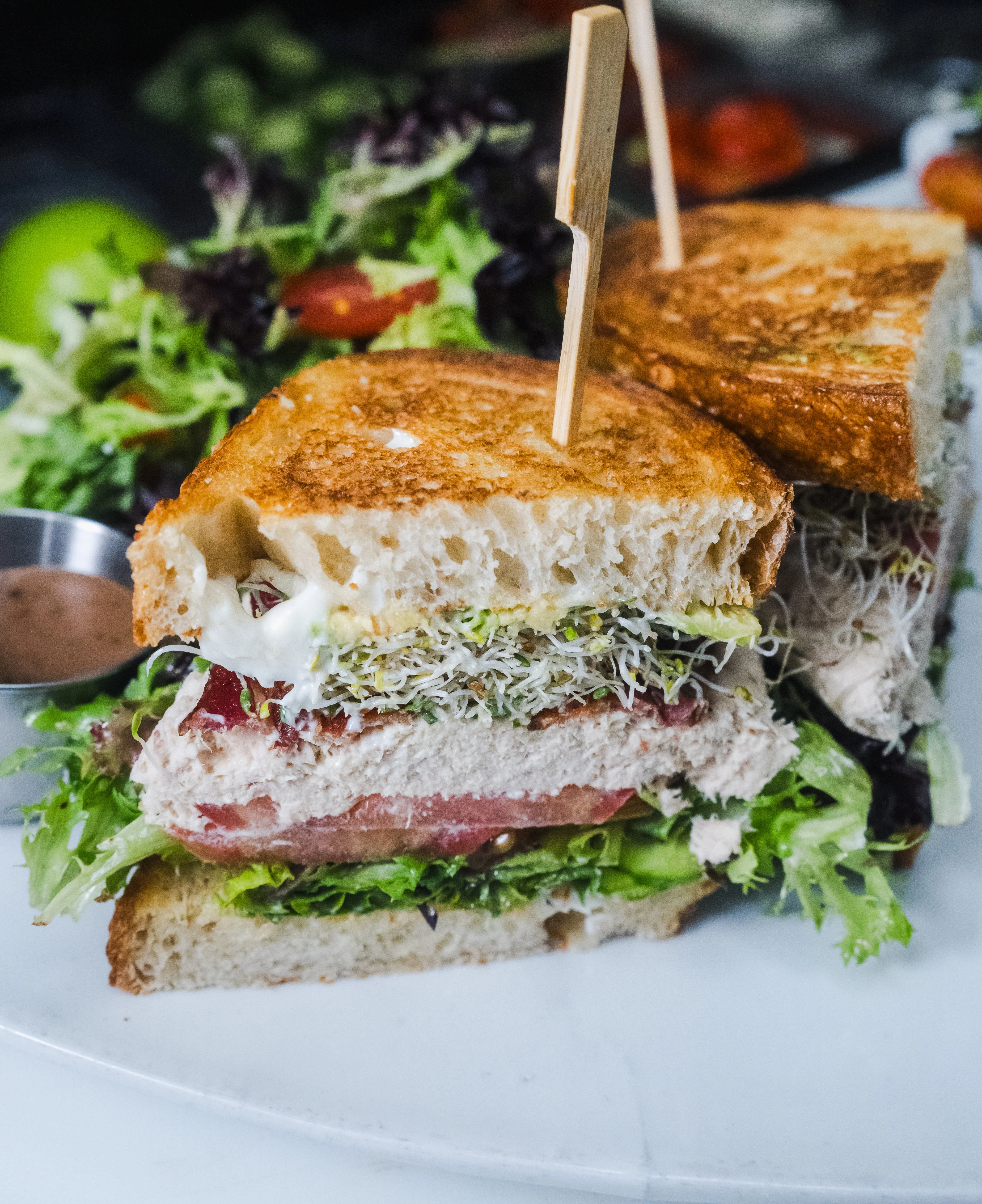 Classic club sandwich with fresh greens and dressing