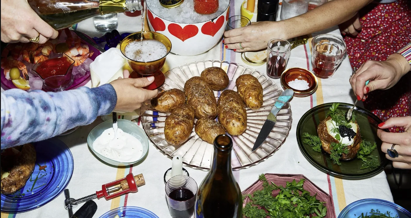 Baked potatoes with caviar and sour cream on a festive dining table