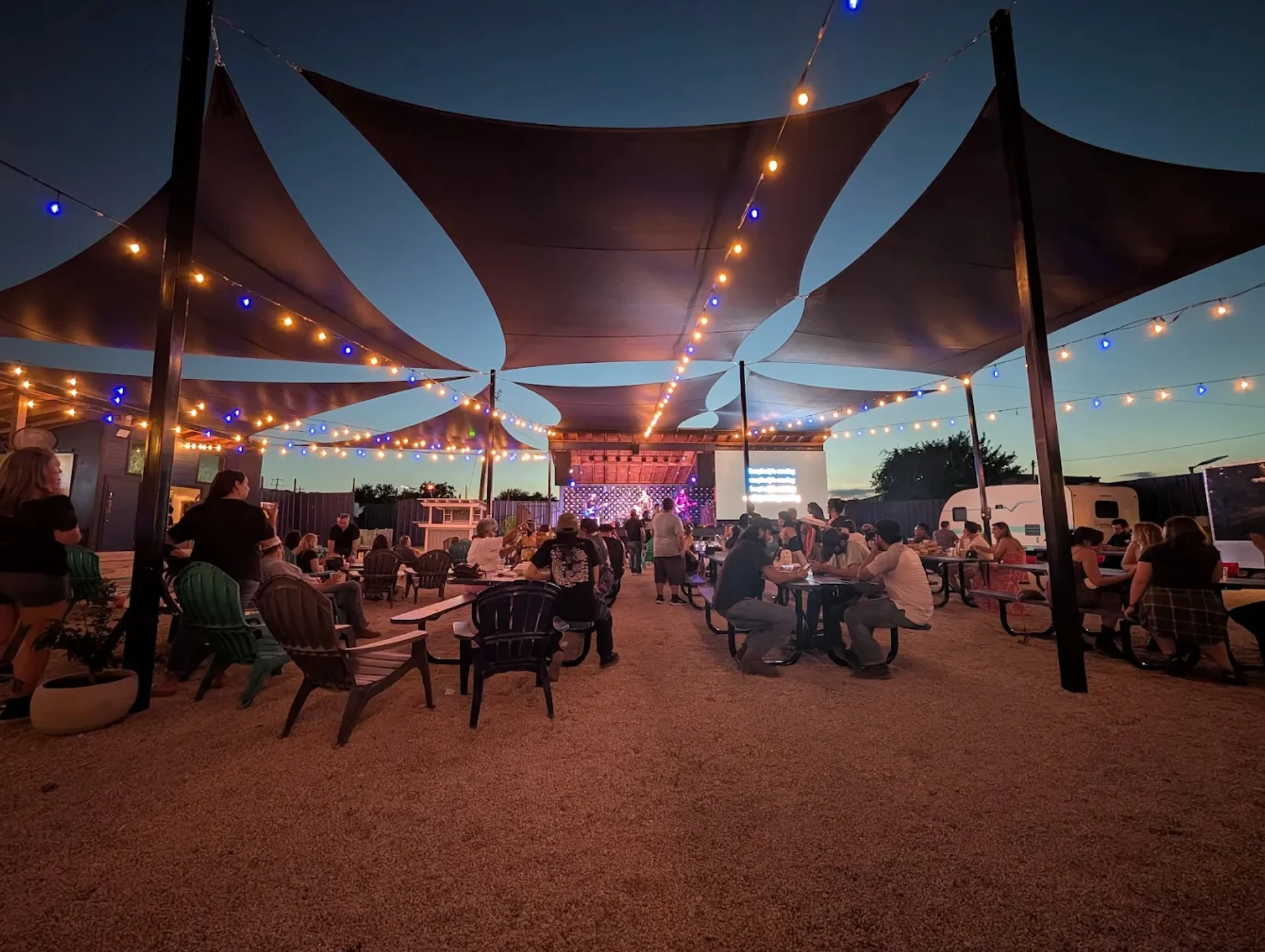 Outdoor dining area with live music and string lights