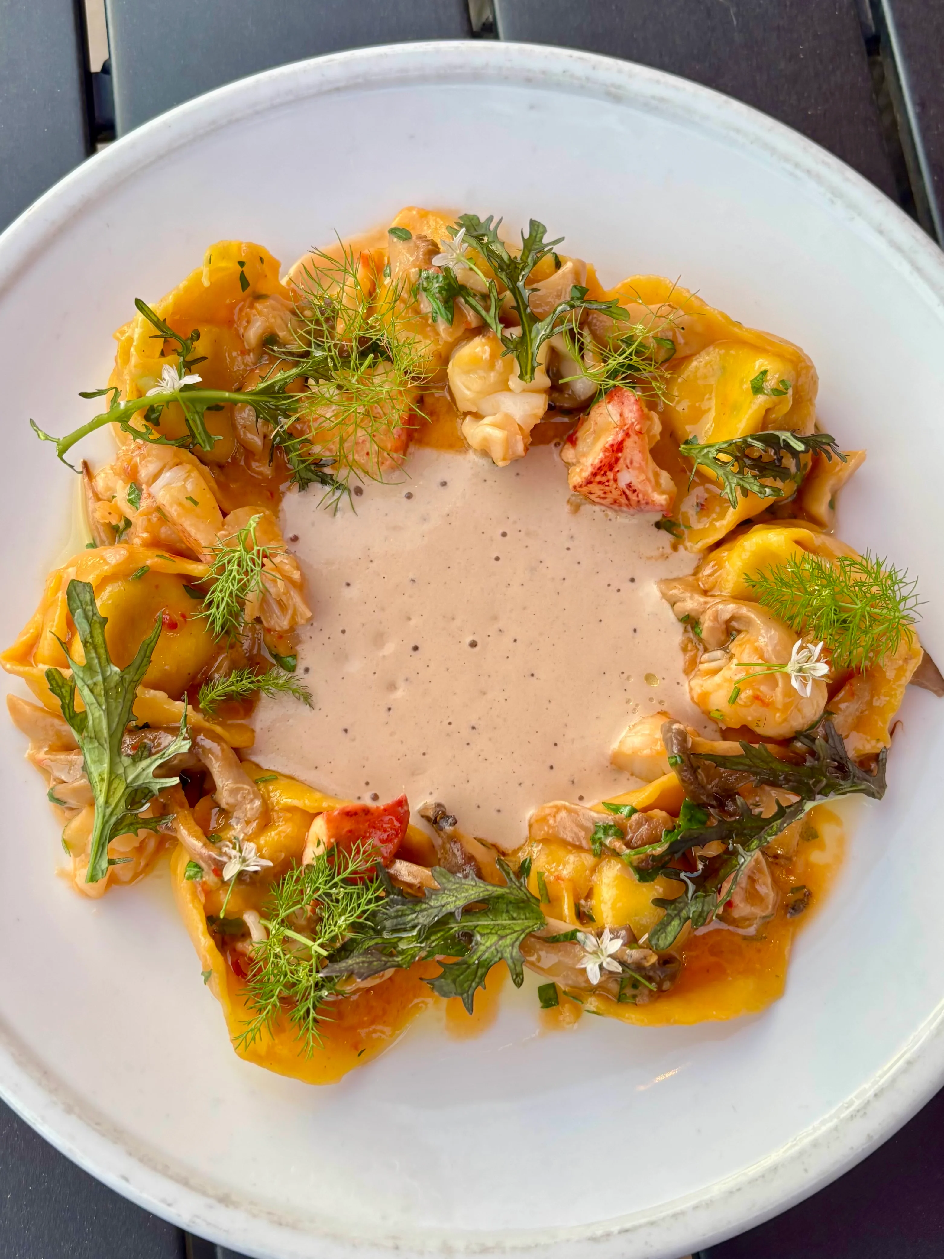 Lobster ravioli with creamy sauce in a fine dining setting