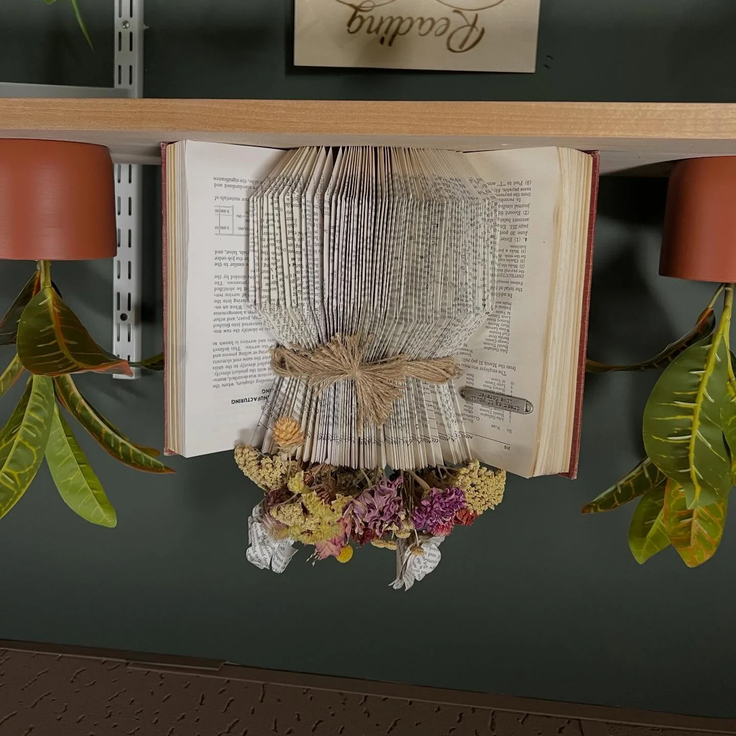 Cozy reading nook with books and comfortable seating in a cafe.
