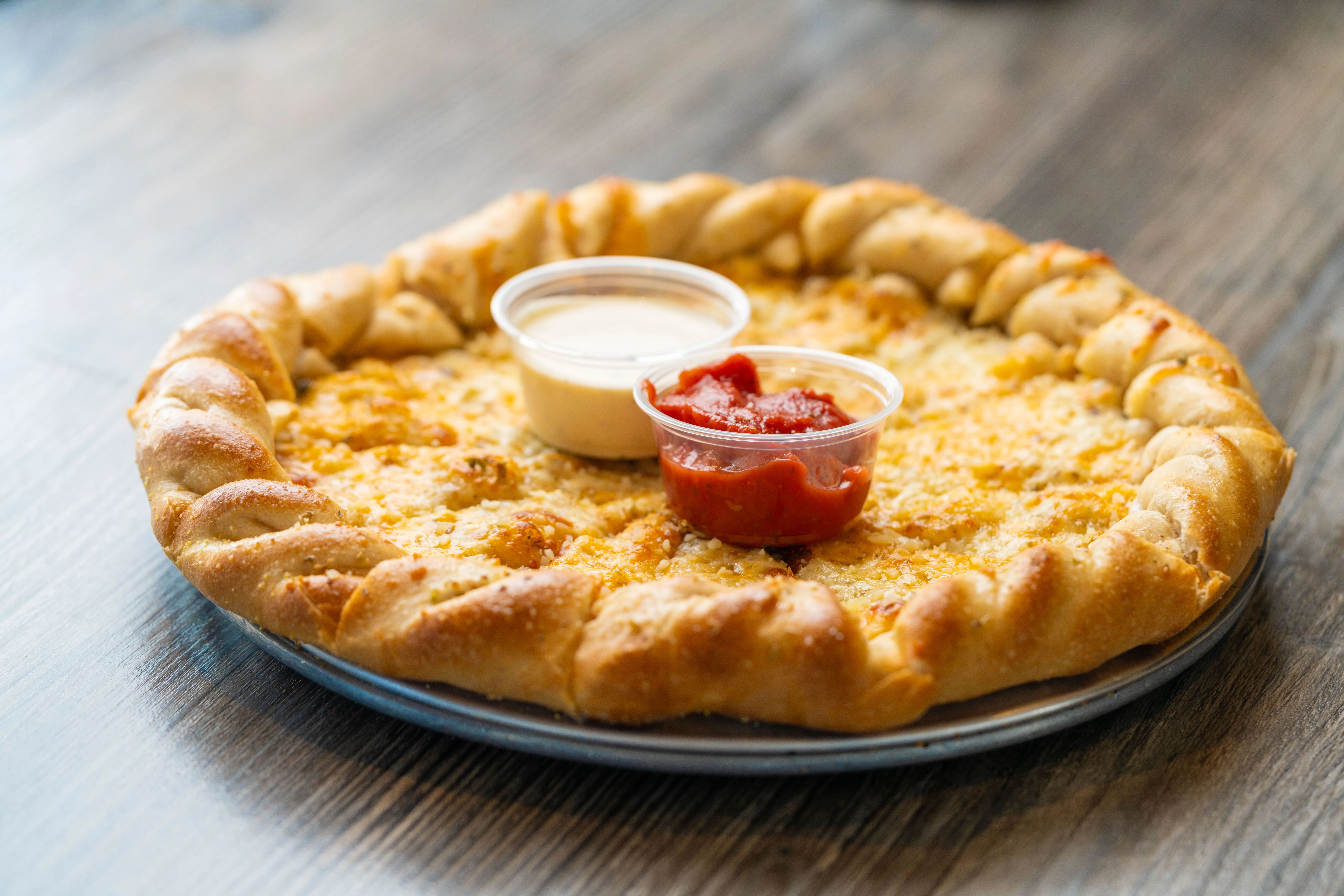Cheesy stuffed crust pizza with dipping sauces