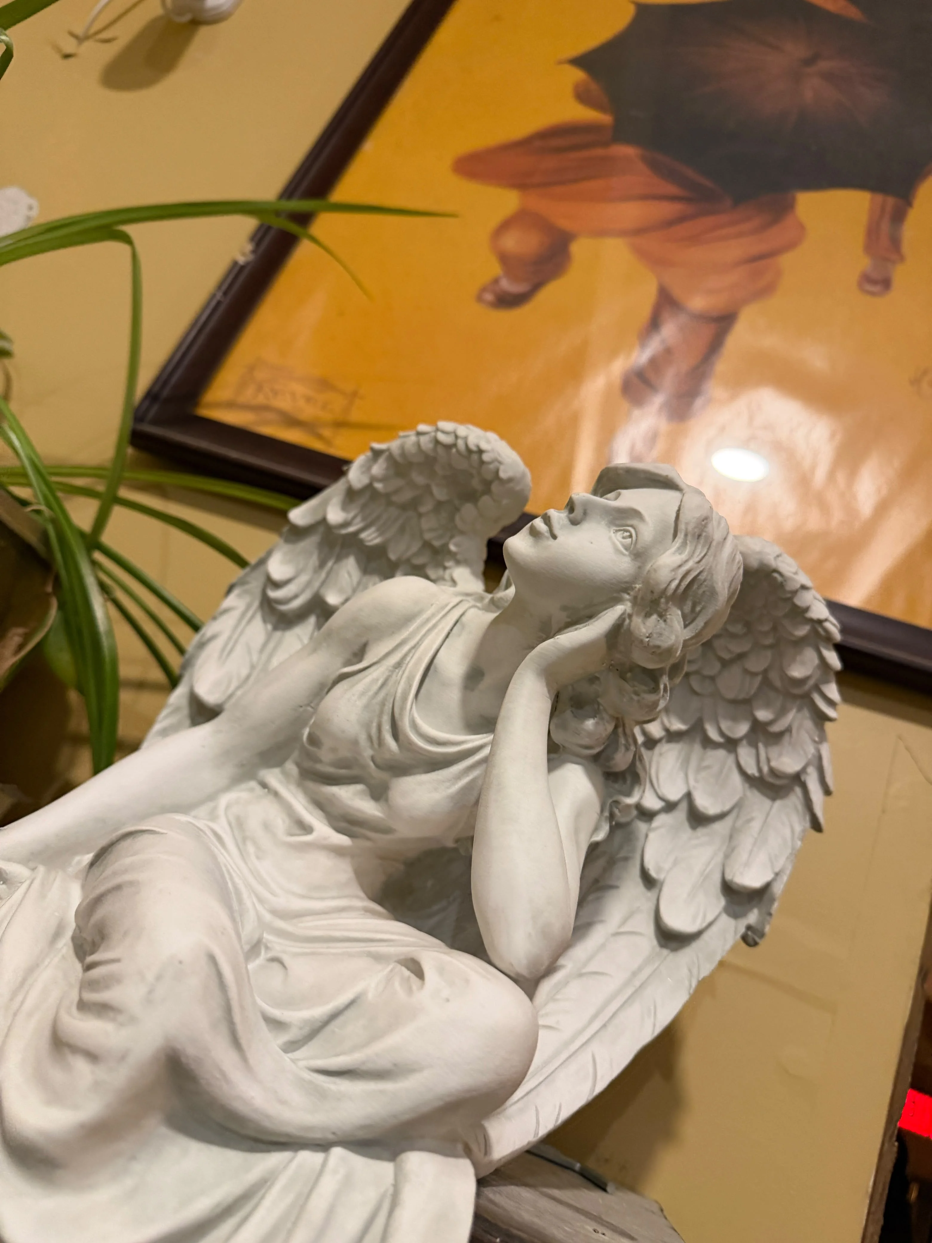 White angel sculpture among the decorative details at Villa Italiana