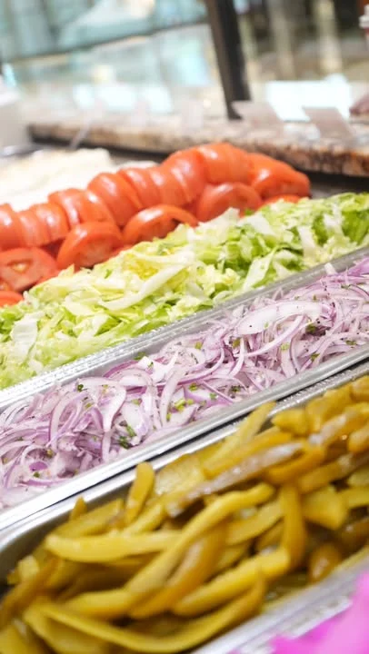 Fresh salad bar with vibrant vegetables for tacos