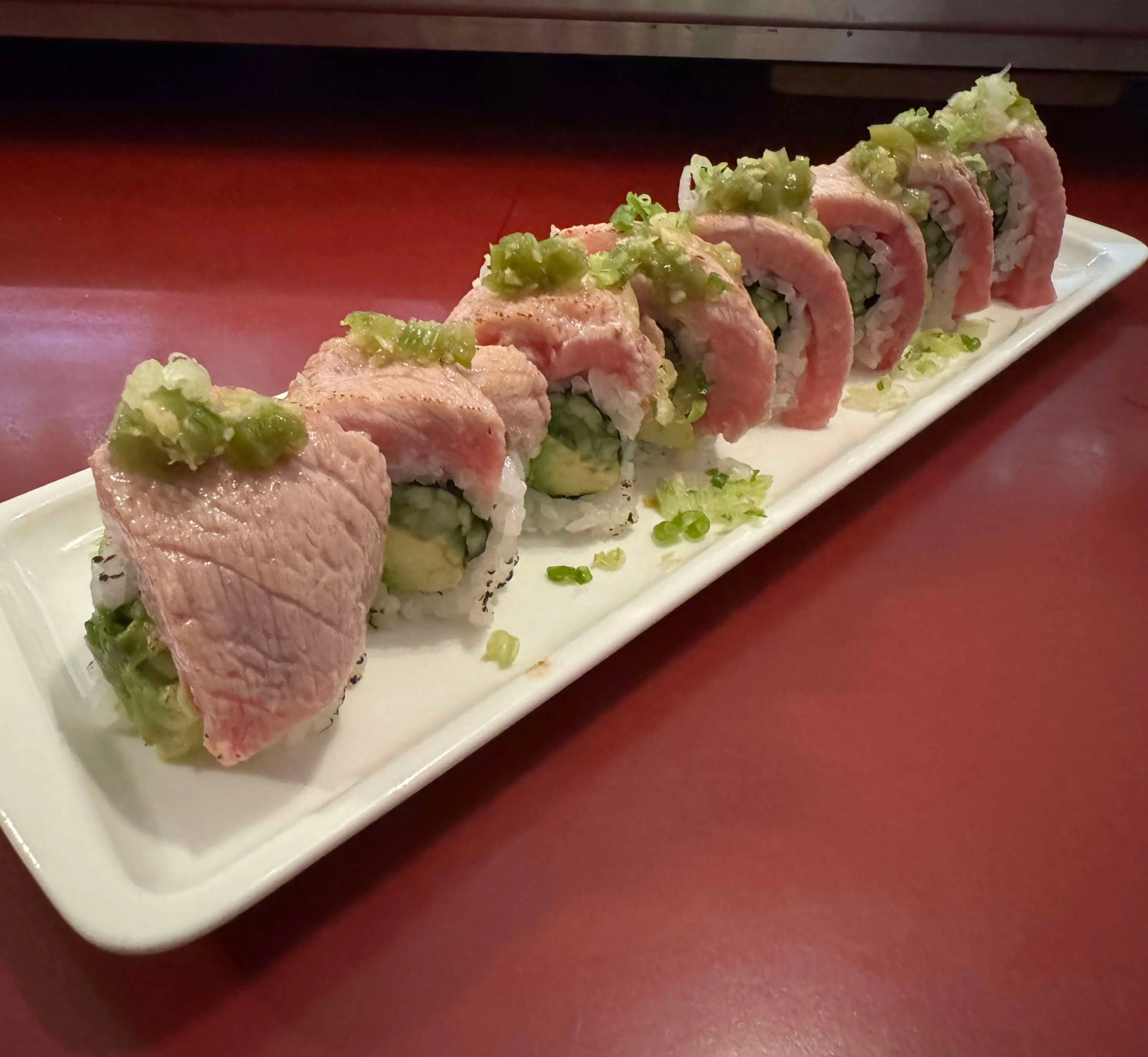 Japanese sushi rolls with fresh tuna and wasabi garnish