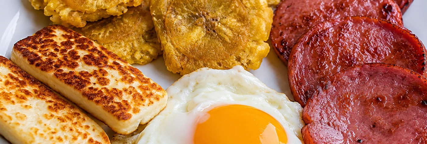 Traditional Caribbean breakfast platter with fried plantains and egg