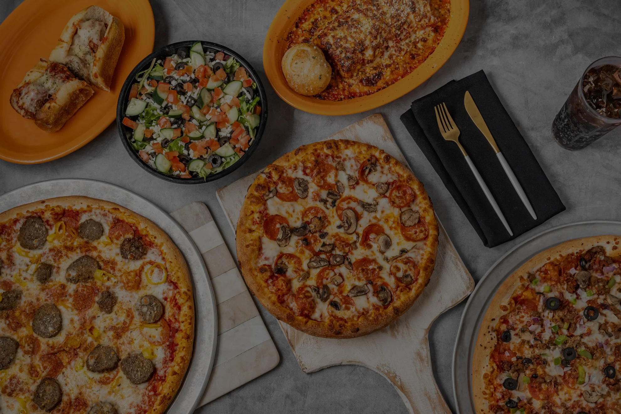 Assorted pizzas and salad in a casual dining setting