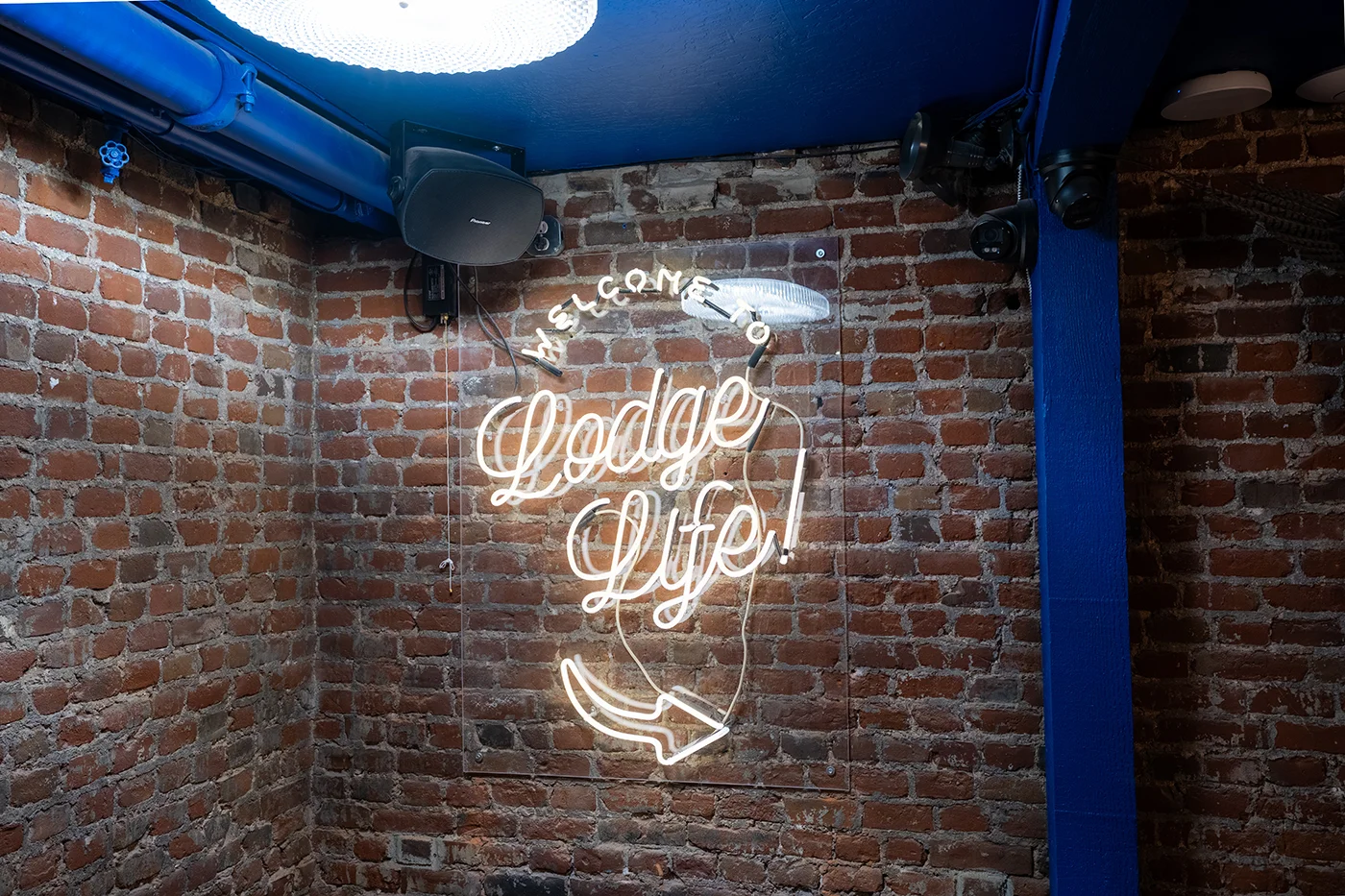Cozy restaurant corner with neon sign and exposed brick wall