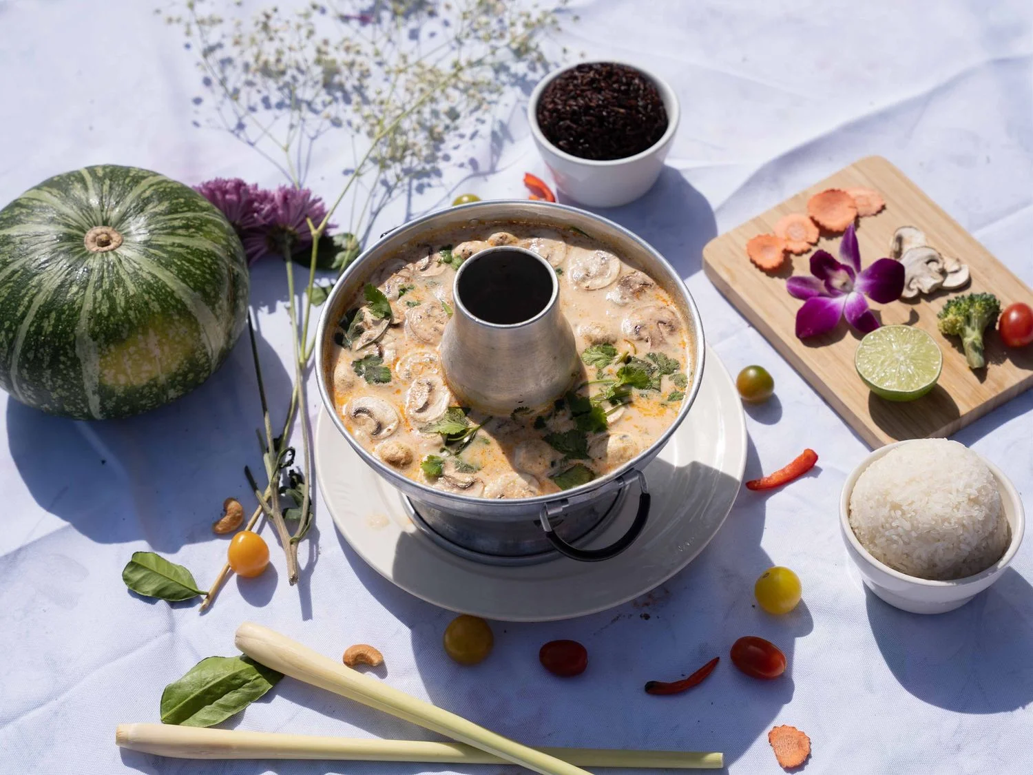 Thai tom kha soup served with rice and fresh herbs