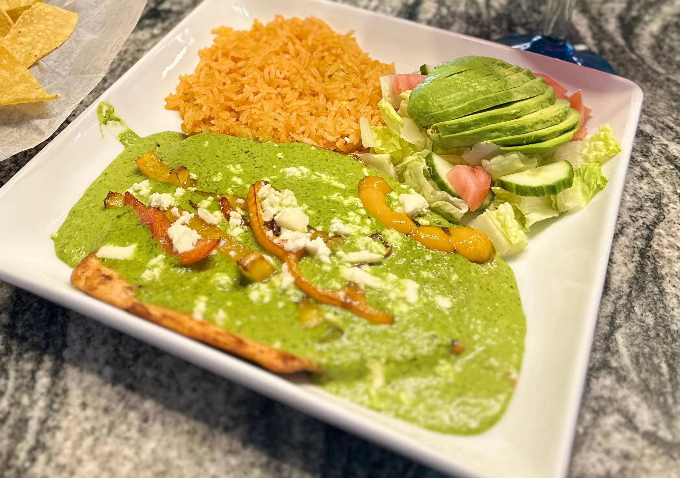 Chicken enchiladas with green sauce and rice