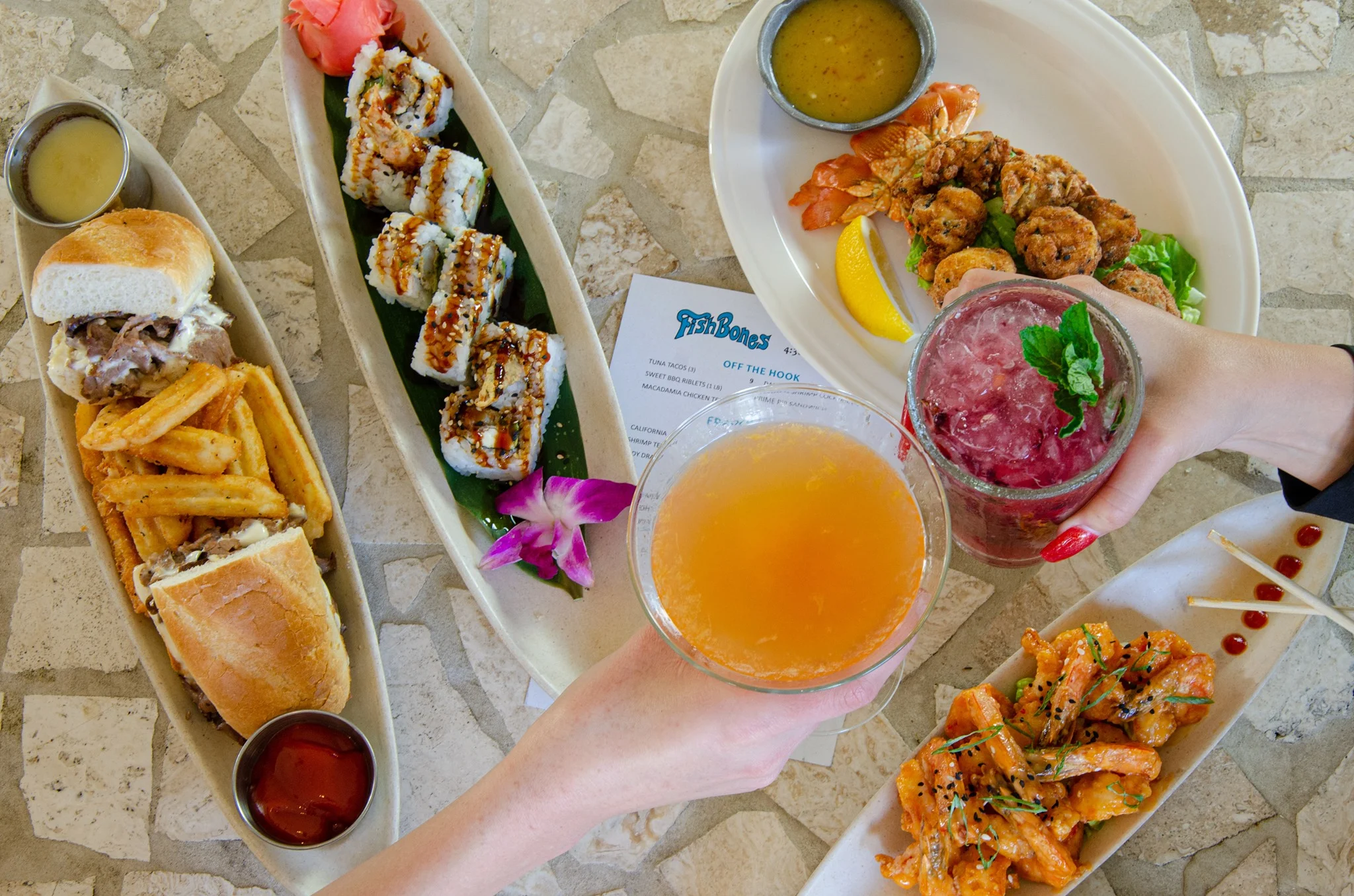Assorted seafood dishes and cocktails at a beachside restaurant