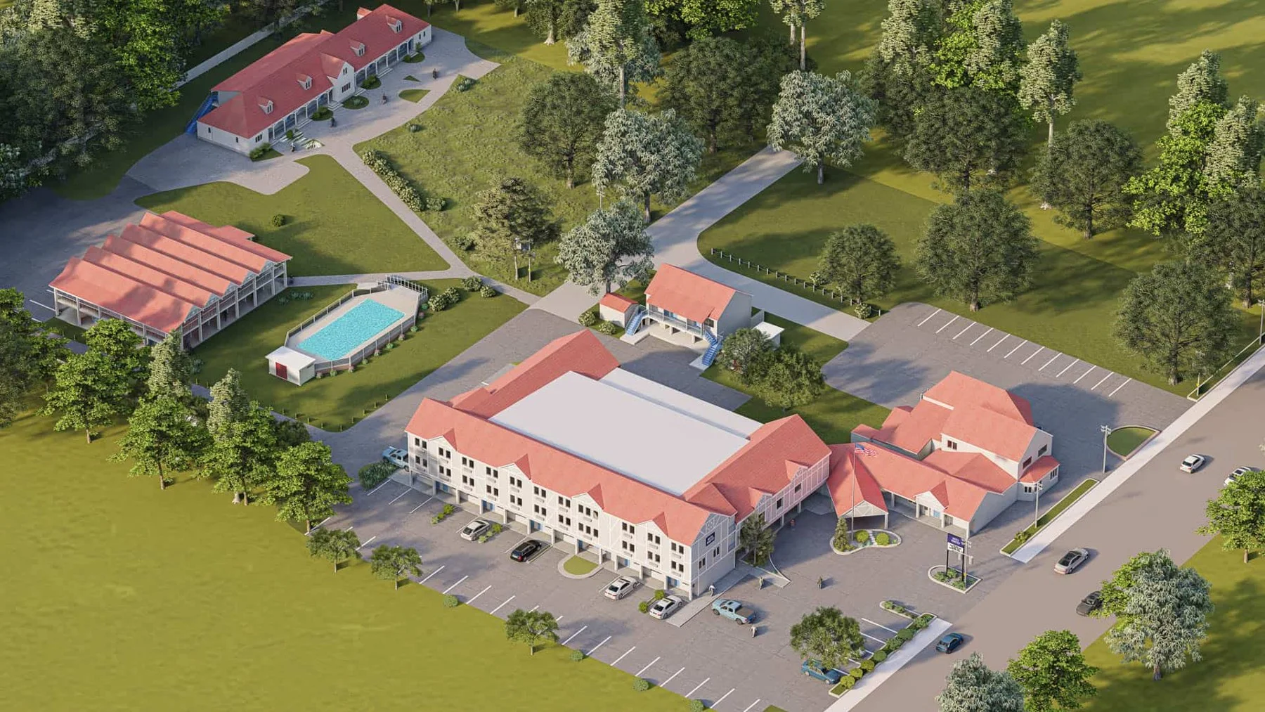 Aerial view of Hotel Manteo showing the outdoor pool, fitness building and parking