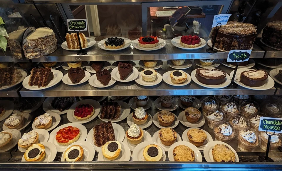 Assorted cakes and desserts in a bakery display case