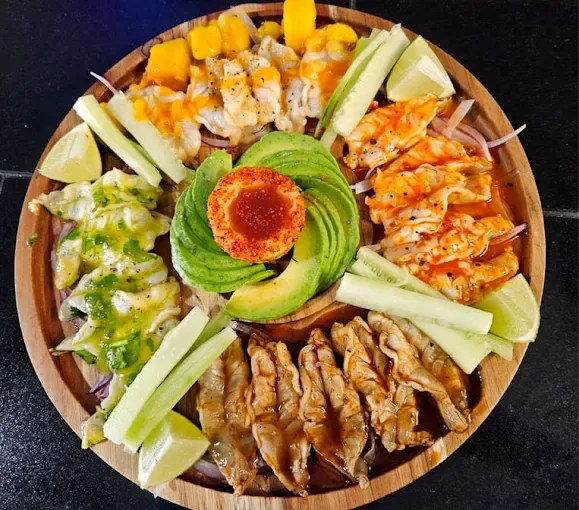 Colorful Mexican ceviche platter with avocado and lime