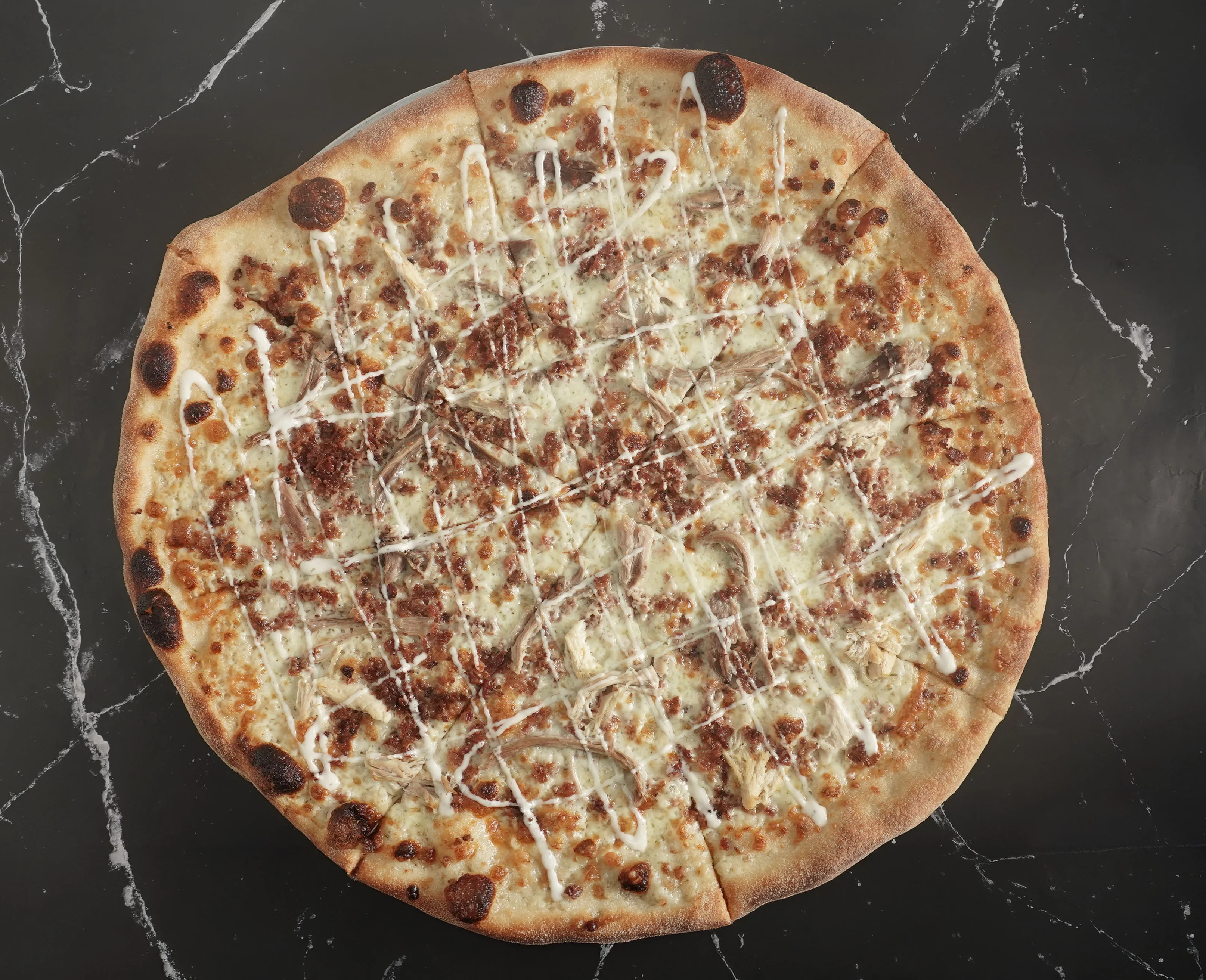 A Chicken Bacon Ranch 18" pizza with Mozzarella, Grilled Chicken, Bacon, Creamy Ranch, and a Golden Crust done the New York Style Way.