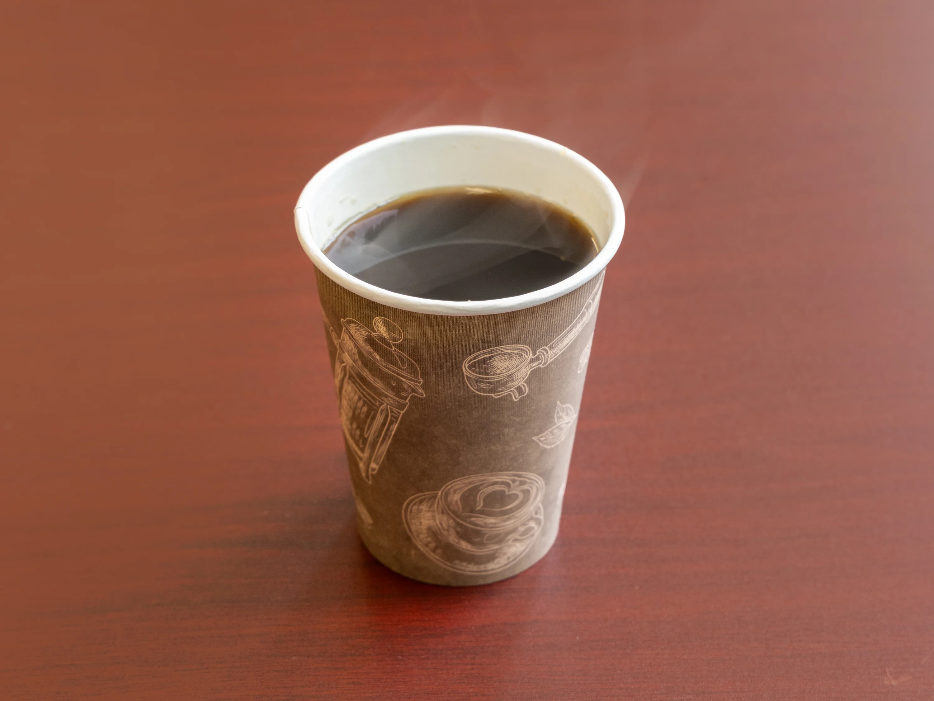 Freshly brewed coffee in a paper cup