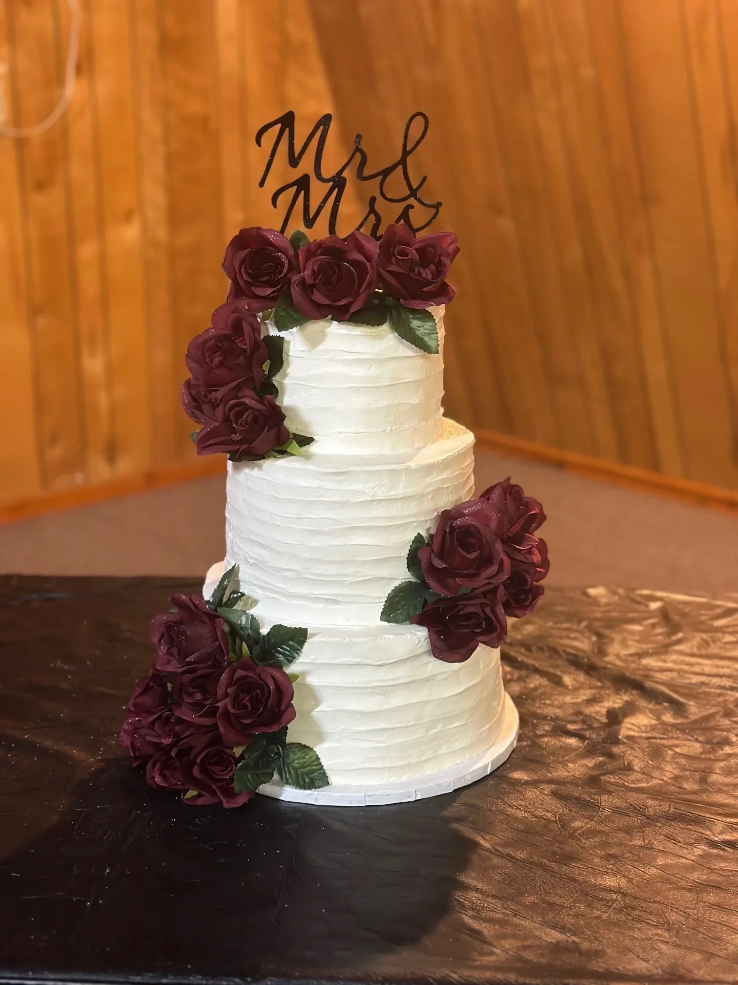 Elegant wedding cake with roses and Mr & Mrs topper