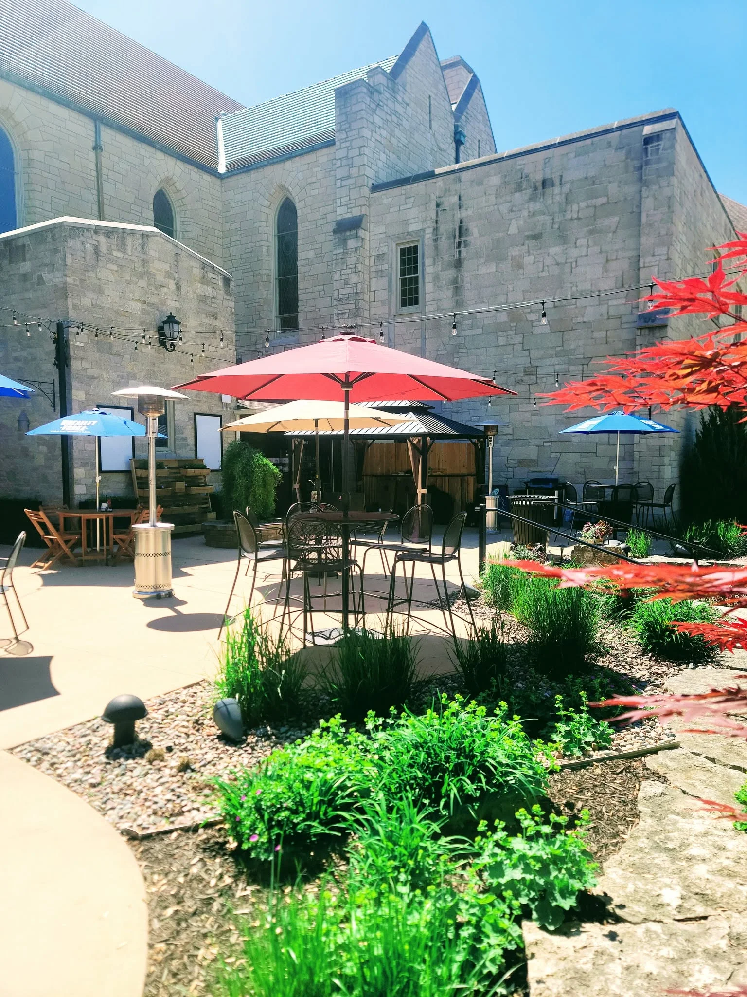 Outdoor dining area with colorful umbrellas and stone architecture