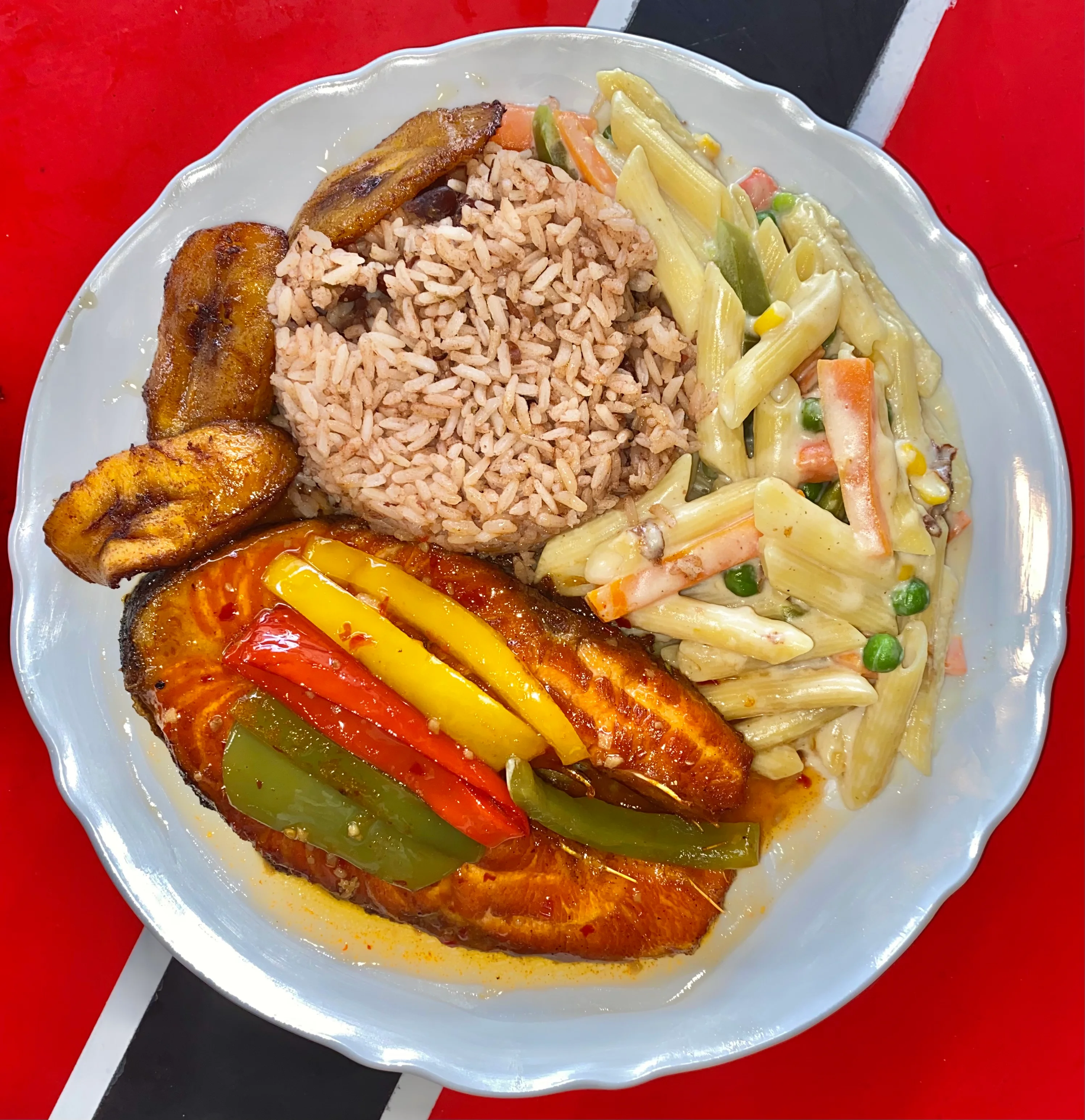 Caribbean-style grilled fish with rice and pasta salad