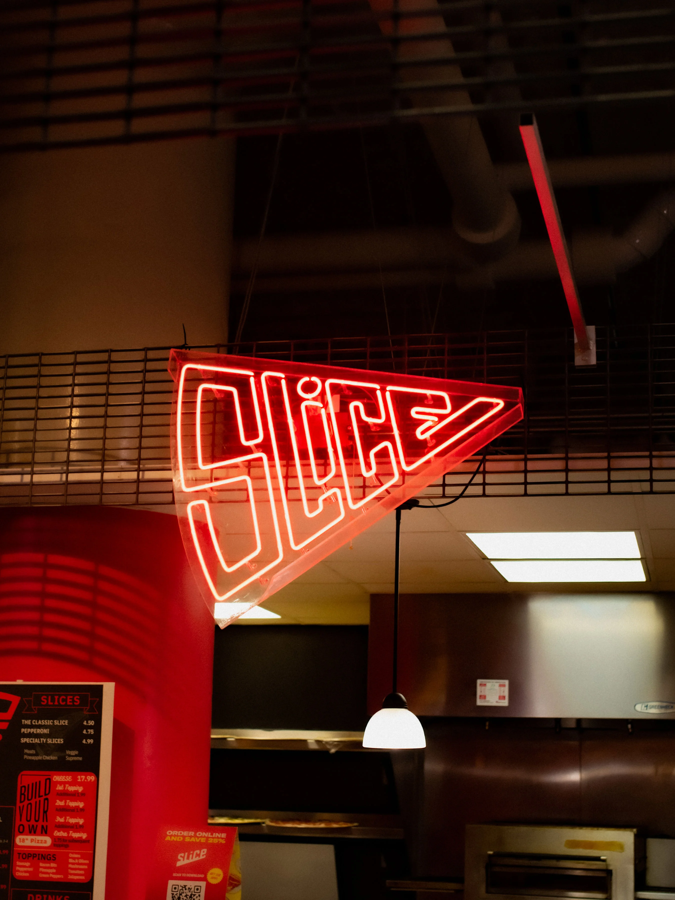 Neon sign for a pizza restaurant named Slice
