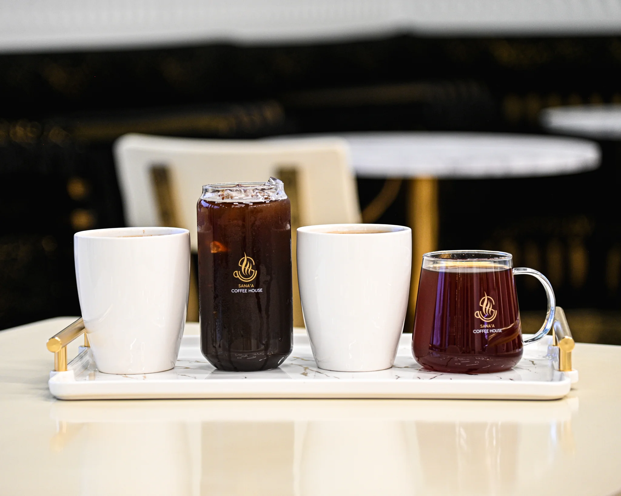 Assorted coffee drinks on a stylish tray at a modern café