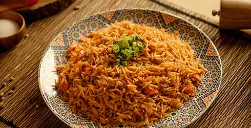 Nigerian jollof rice garnished with green onions