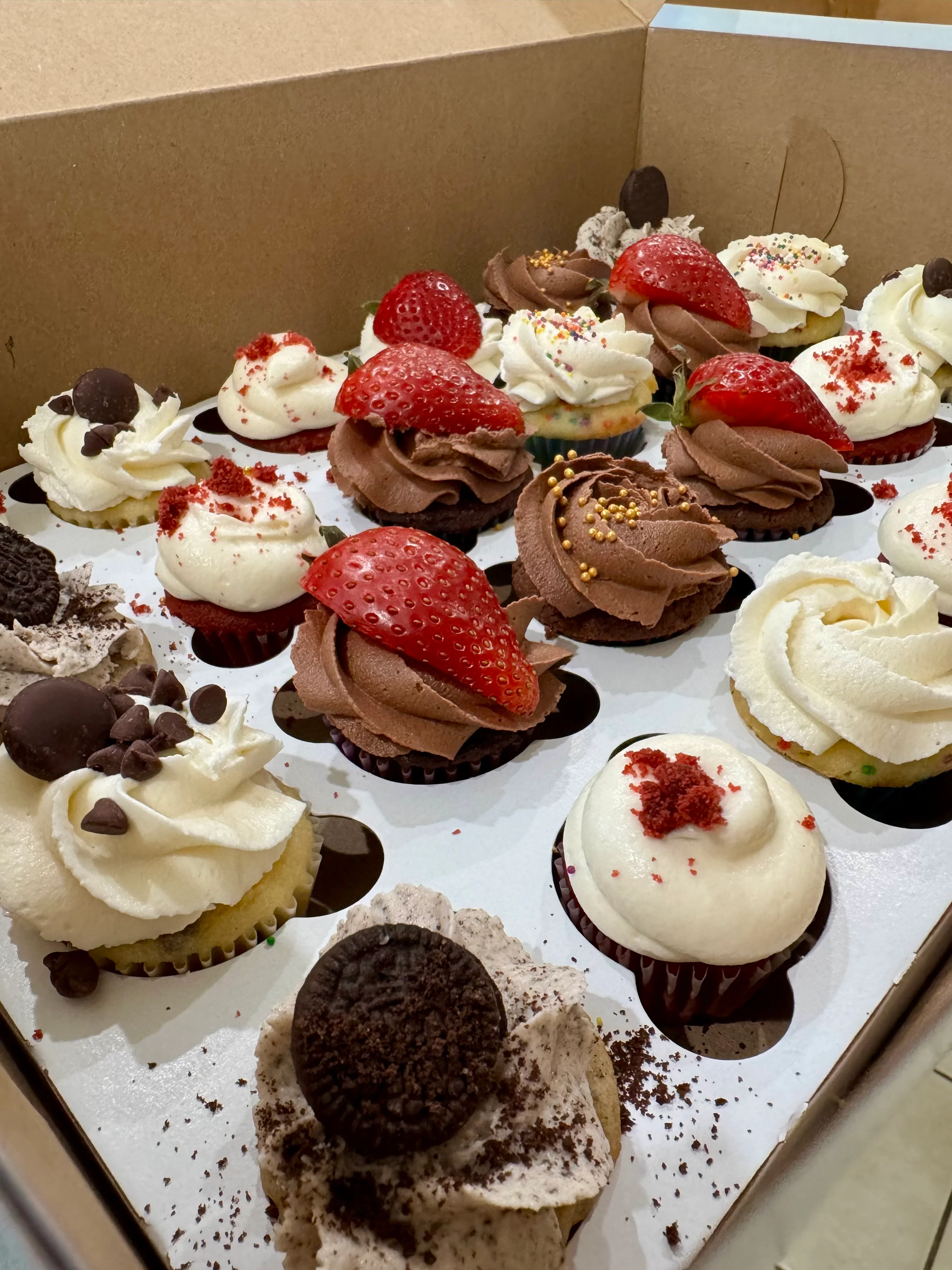 Assorted gourmet cupcakes in a box