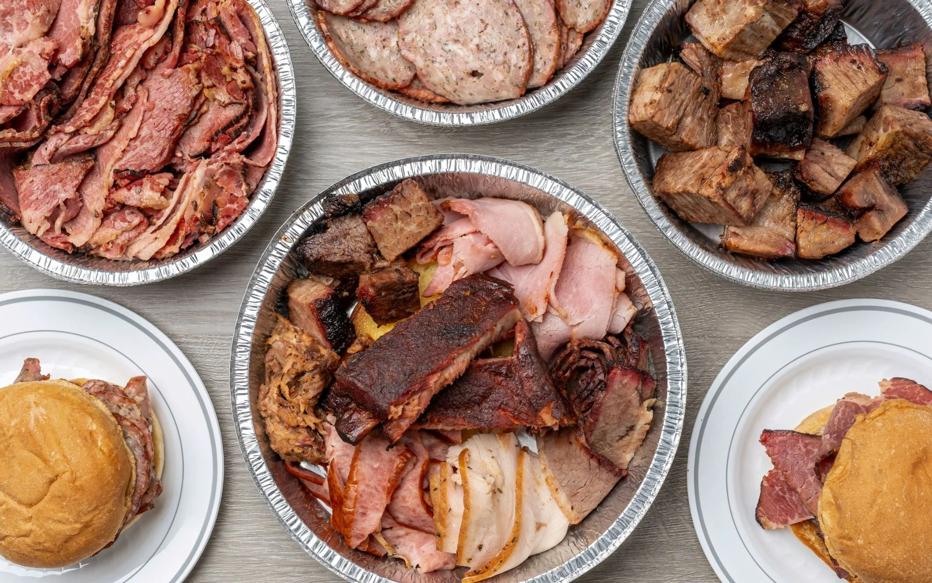 Trays of smoked brisket, burnt ends and pulled pork from Hawg Jaw Que & Brew