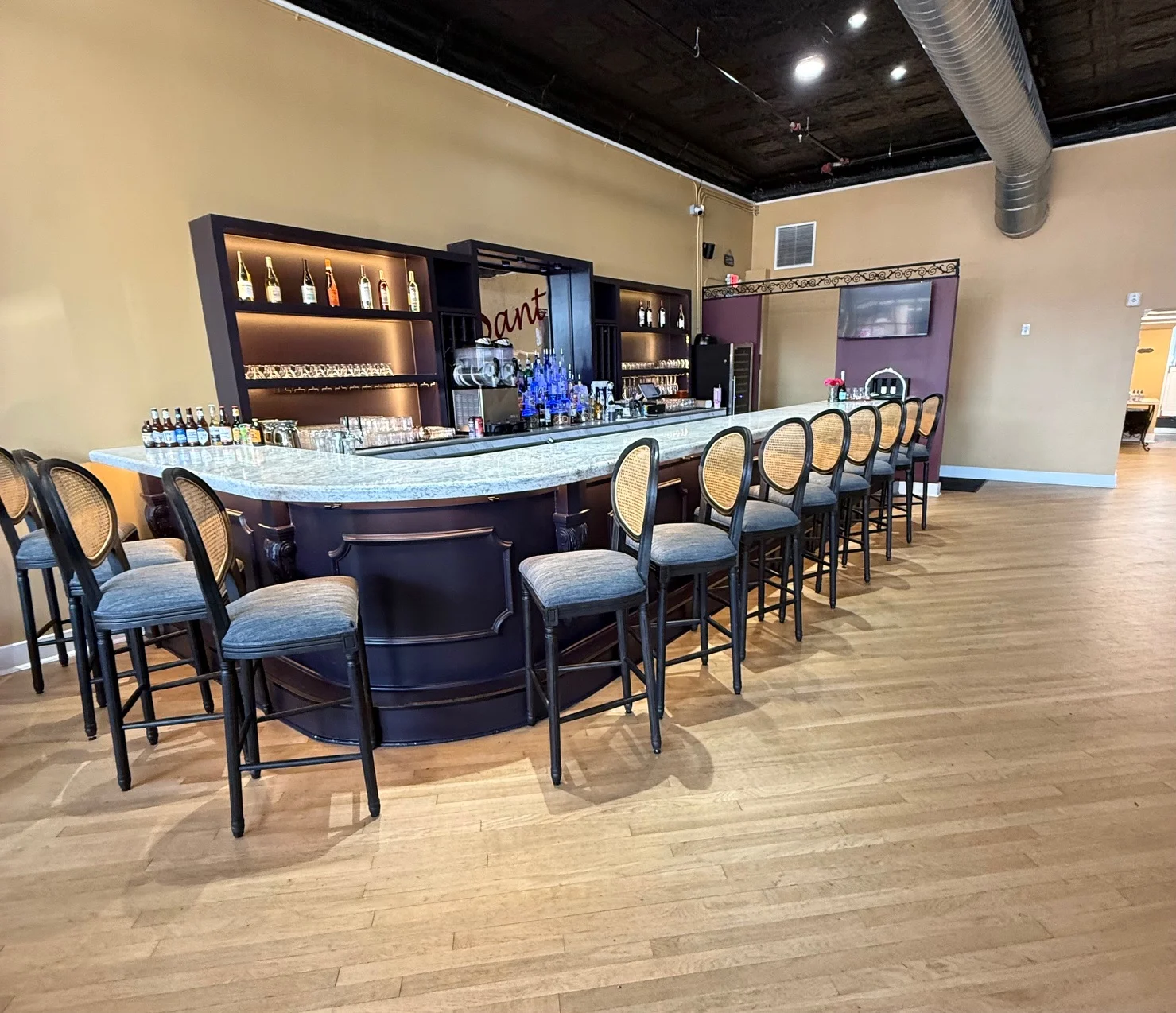 Modern bar counter with stylish seating and illuminated shelves