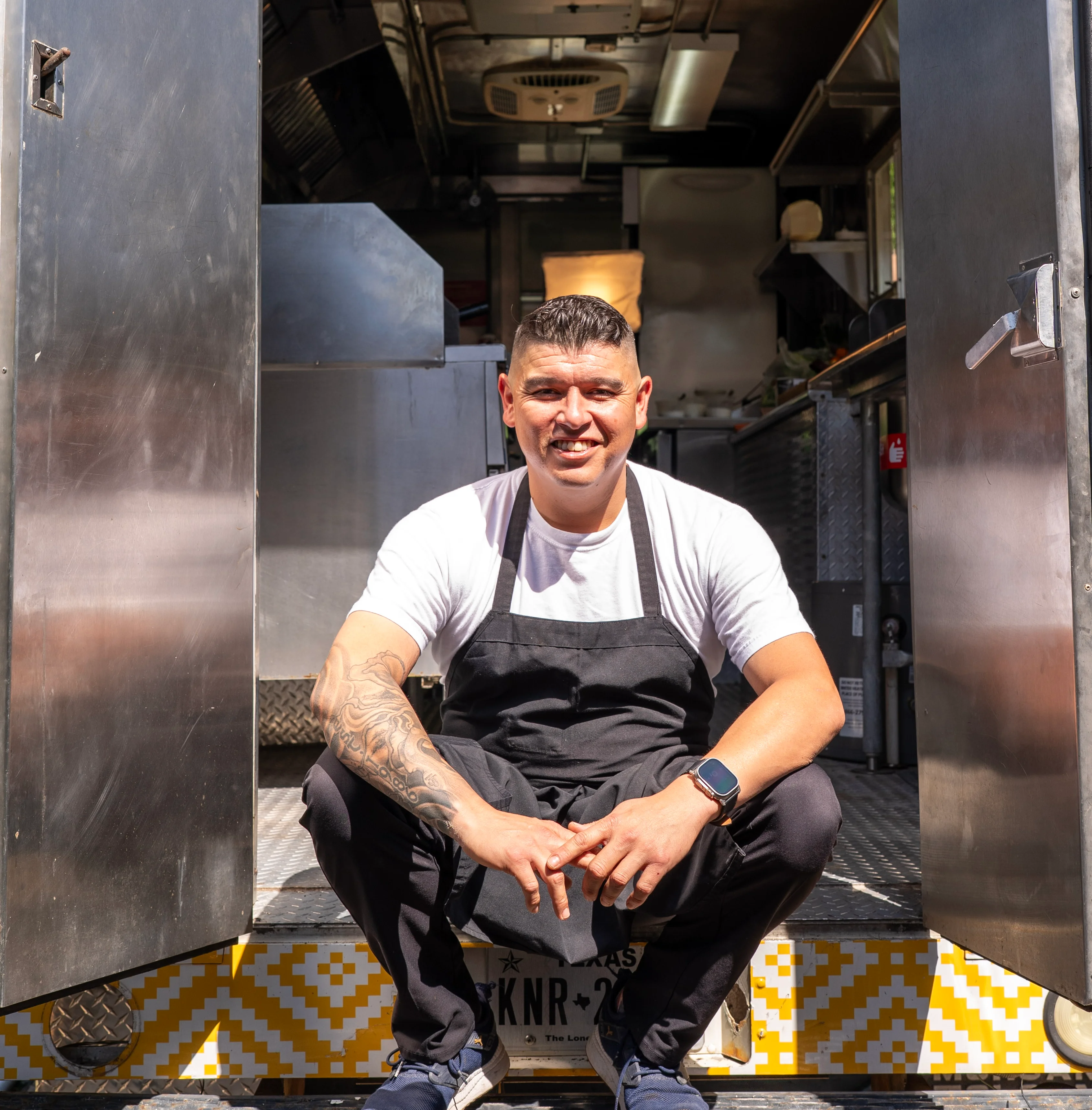 Chef smiling in front of a food truck