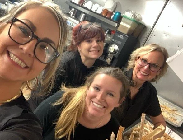 Restaurant staff smiling in a busy kitchen