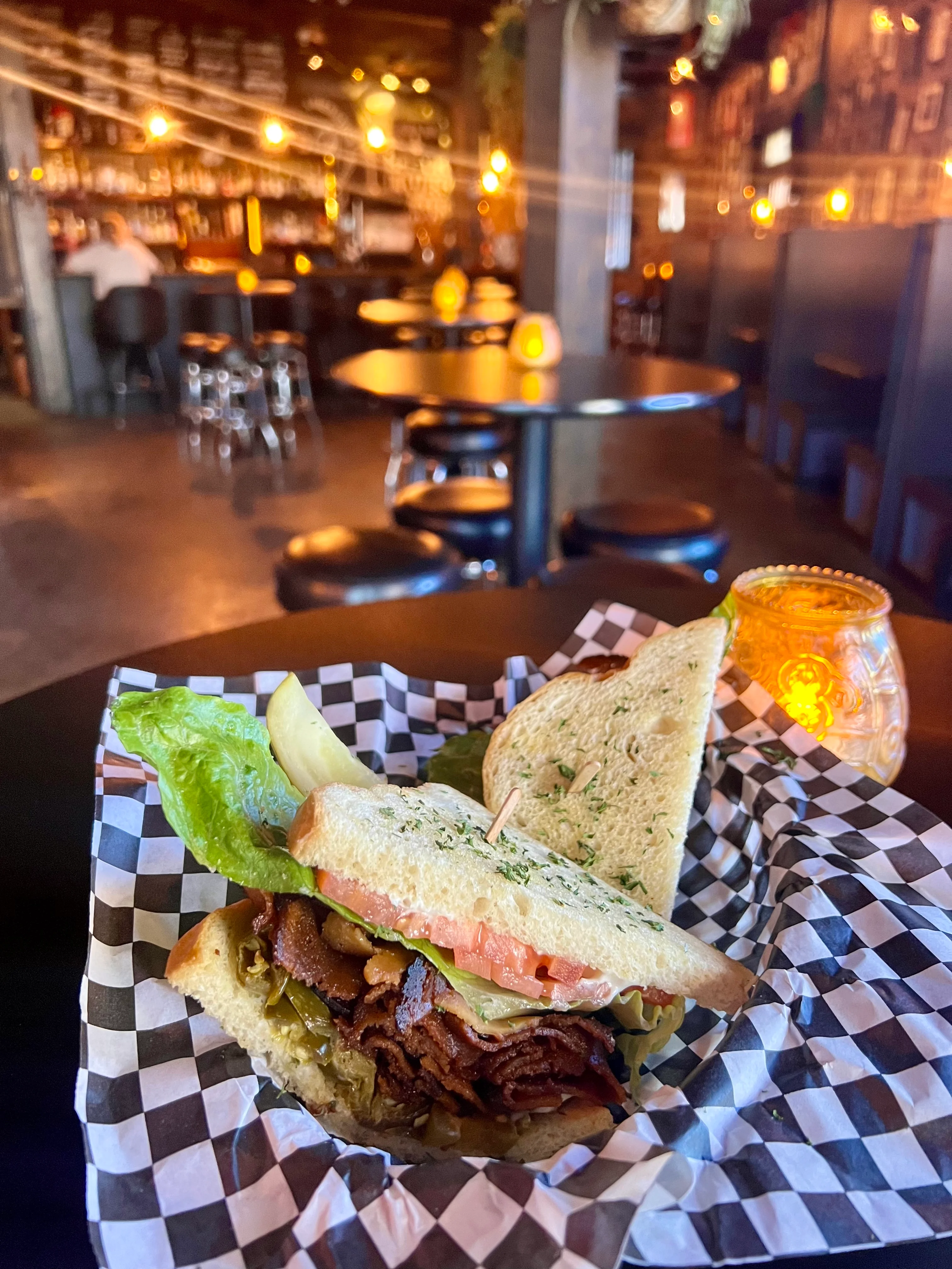 Savory smoked brisket sandwich in a cozy bar setting