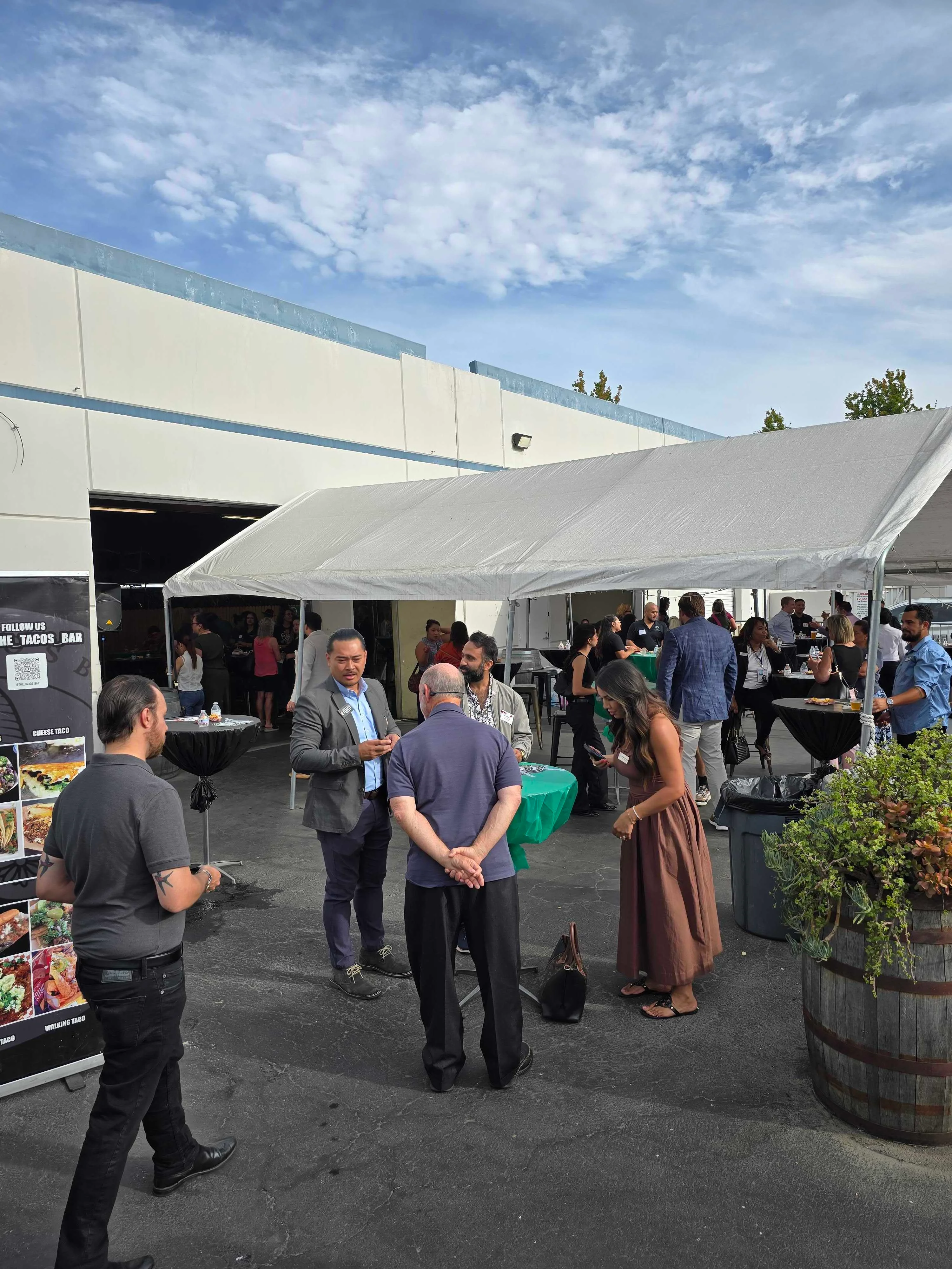 Outdoor gathering with people socializing at a restaurant event
