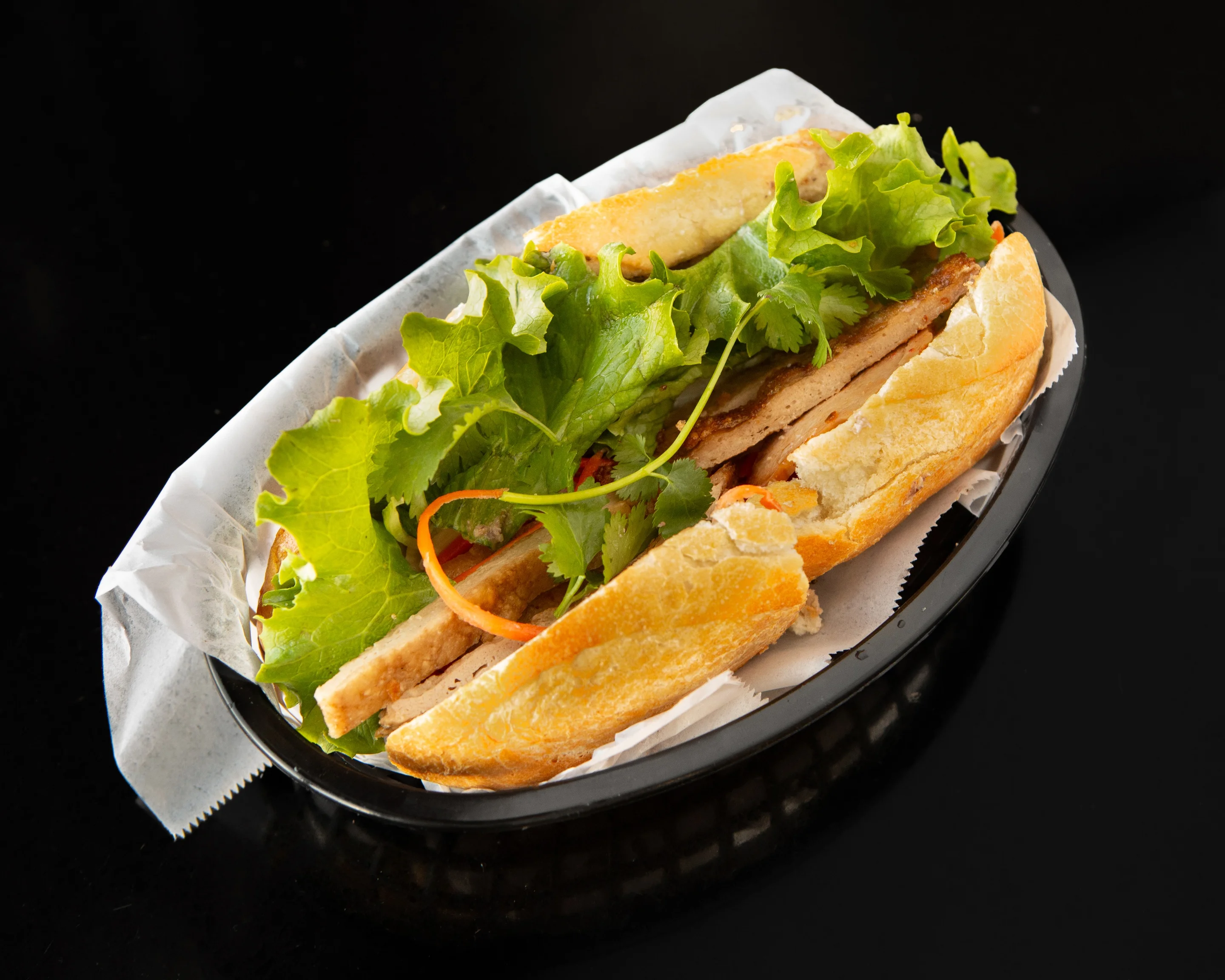 Vietnamese banh mi sandwich with fresh herbs and vegetables