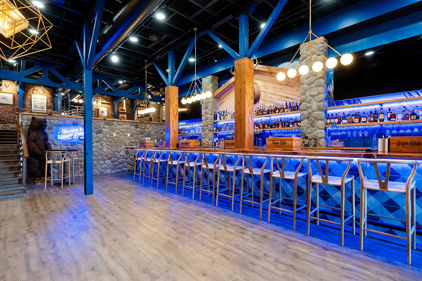 Stylish bar interior with blue lighting and stone accents