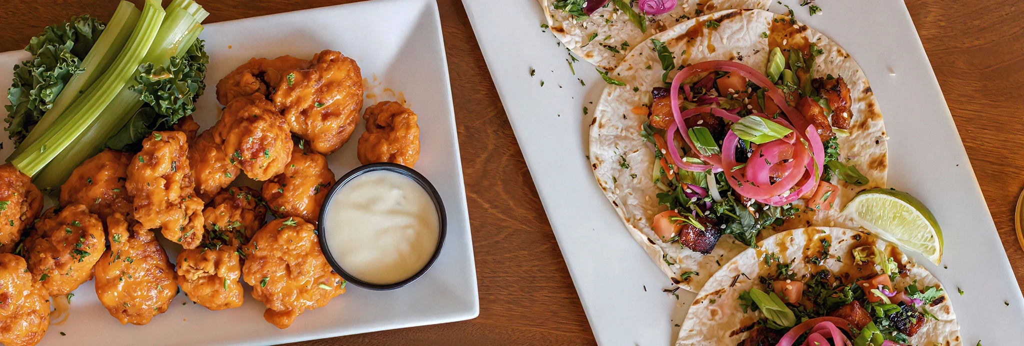 Buffalo cauliflower wings with tacos in a vibrant restaurant setting