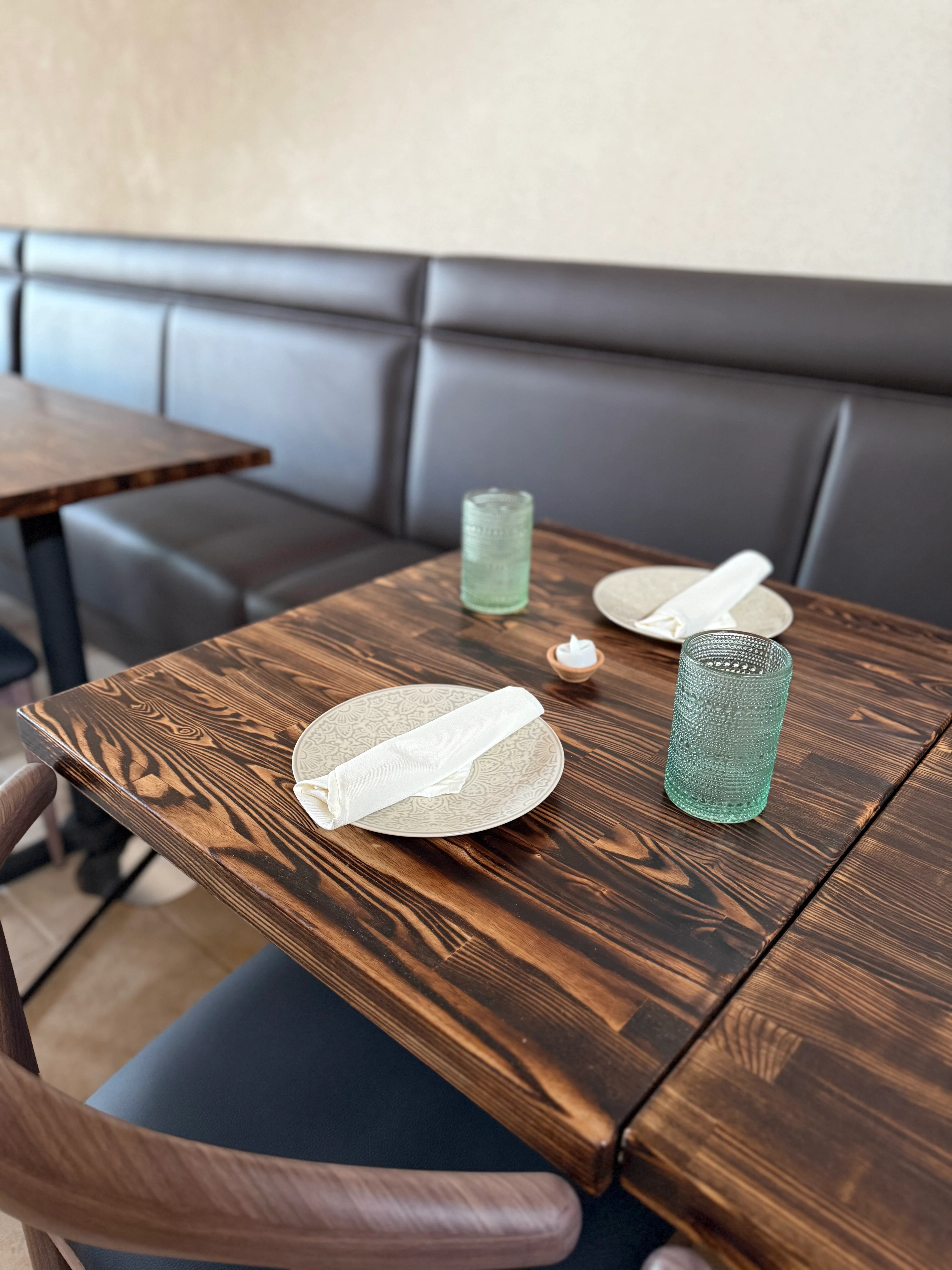 Cozy restaurant dining table set with plates and glasses