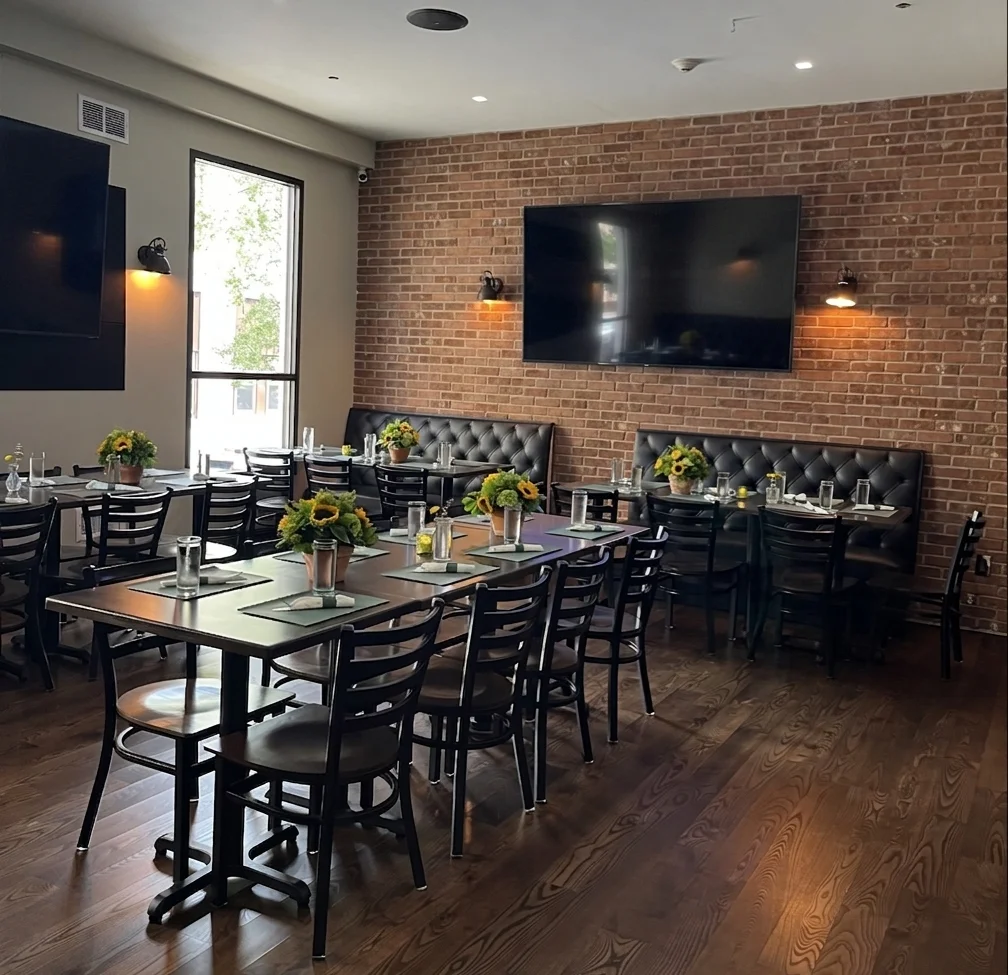 Cozy restaurant interior with wooden floors and brick walls