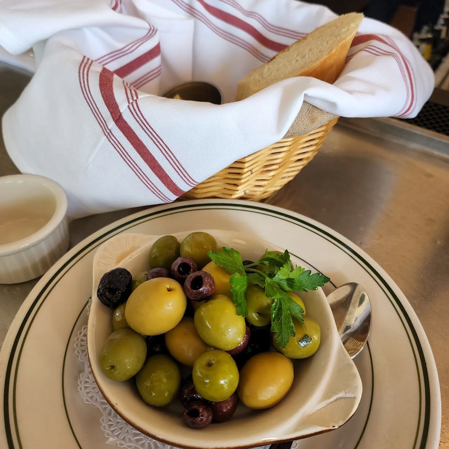 Mediterranean olive dish with assorted olives and fresh herbs